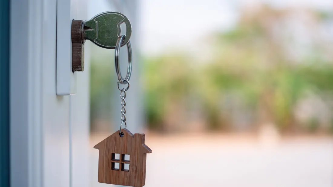 A house key resting in an open front door